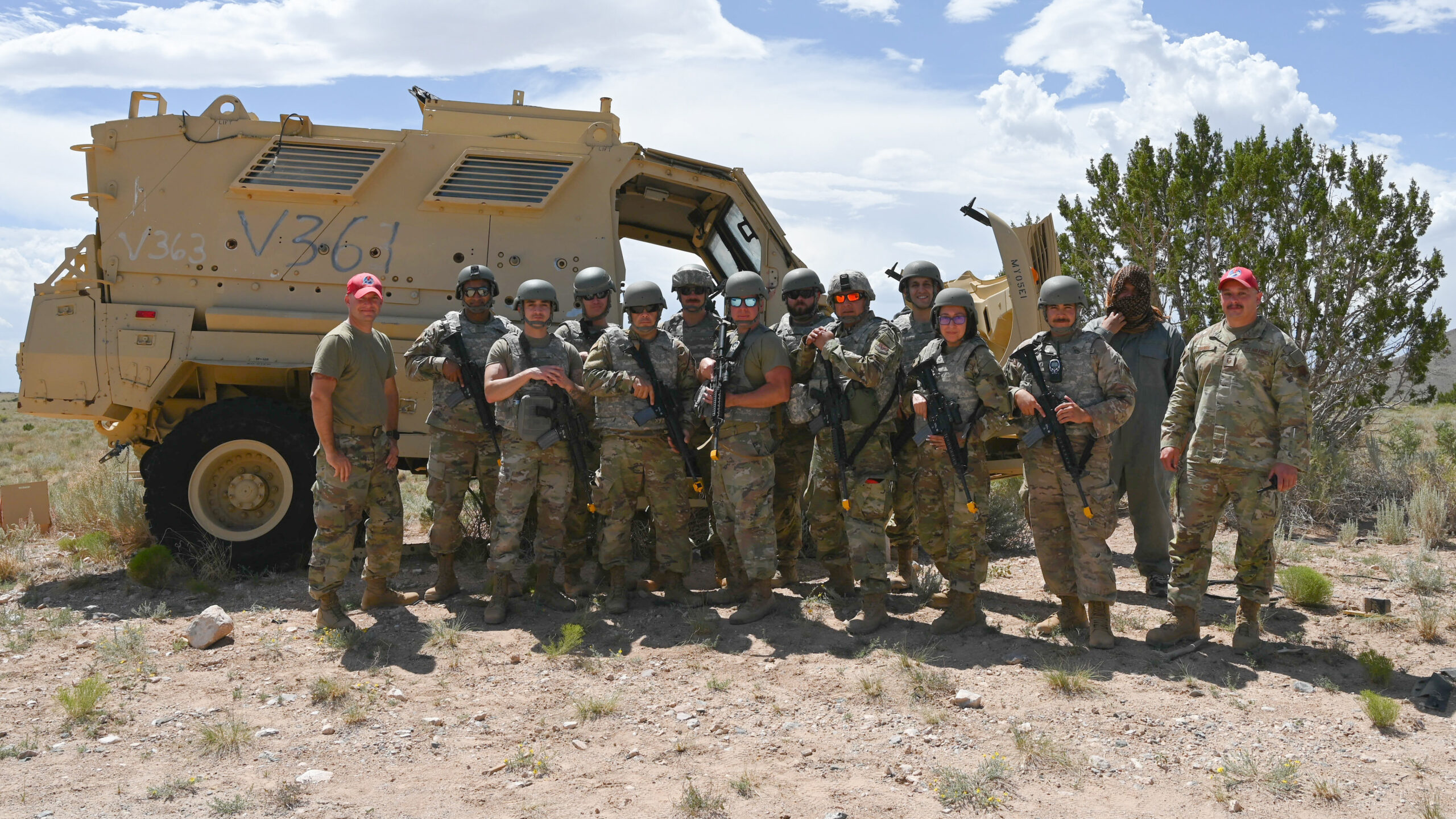 Air National Guard soldiers pose with a Mine-Resistant Ambush Protected vehicle