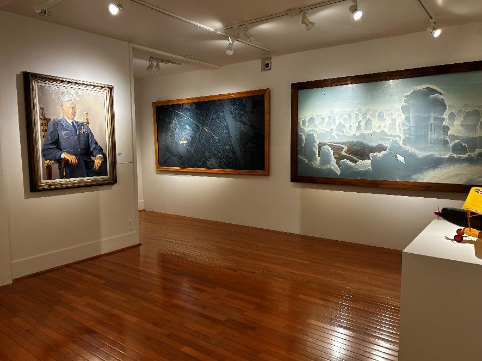 Museum gallery displaying large-scale military paintings