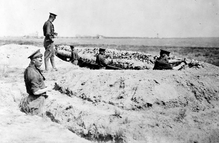 Historical photograph of soldiers positioned in a defensive trench