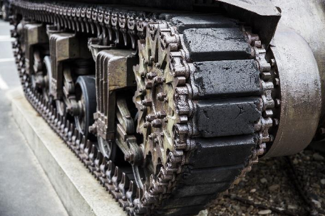 Close-up of a military tank track on display at the museum